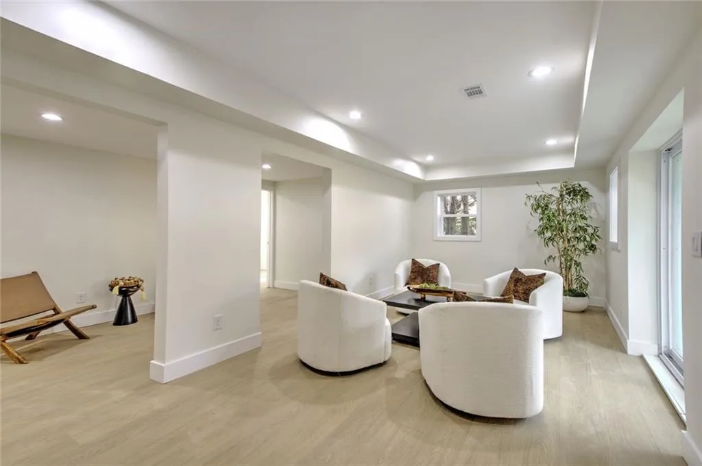 Living area featuring light wood-style flooring and recessed lighting