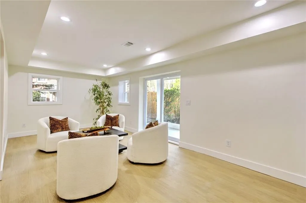 Living area with recessed lighting, light wood-style flooring, and plenty of natural light