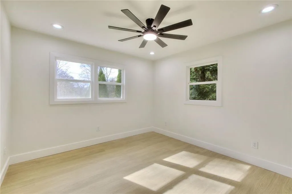 Spare room with light wood-style flooring, healthy amount of natural light, recessed lighting, and a ceiling fan