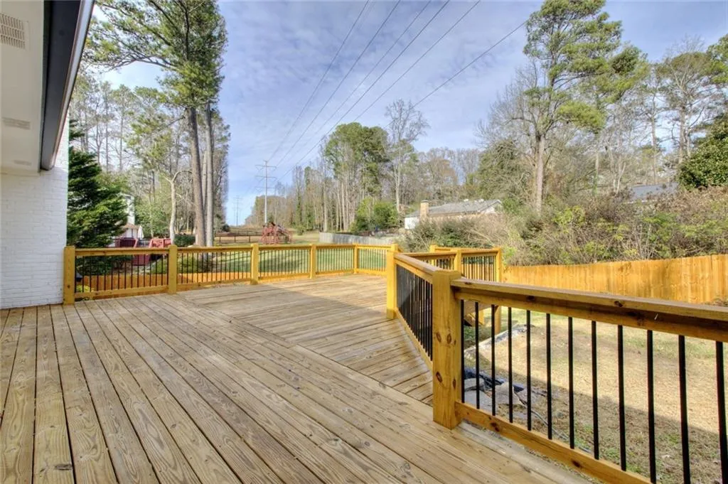 Wooden deck with a fenced backyard
