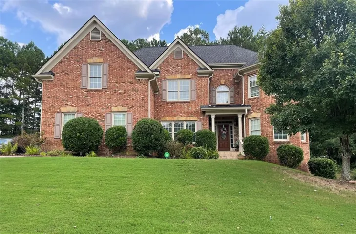Brick exterior with gabled roof lines, featuring white trim and shutters