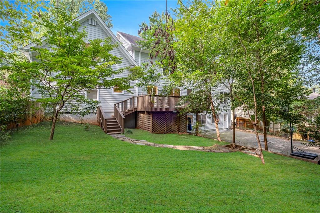 View of yard with a wooden deck
