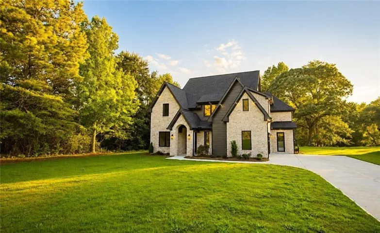 Contemporary residence featuring a light brick facade and dark siding accents
