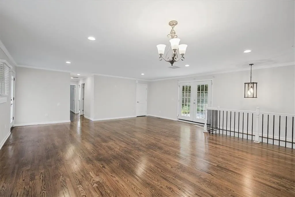 Hardwood flooring throughout, recessed lighting, and crown molding