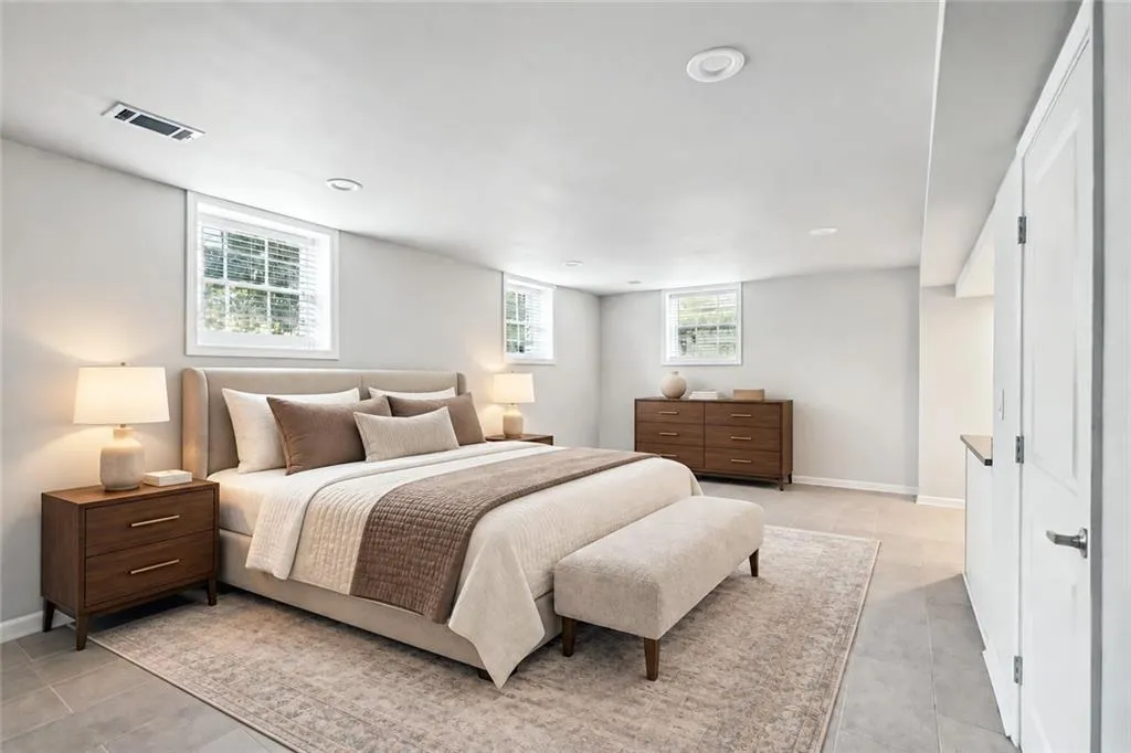 Recessed lighting, multiple windows with blinds, light gray wall paint, and gray tile flooring