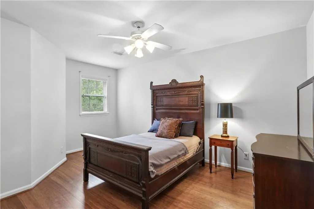 Bedroom featuring wood finished floors and ceiling fan
