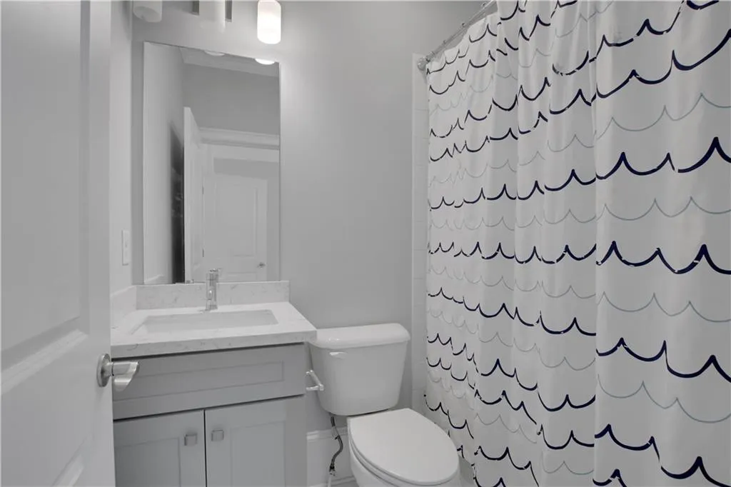 Full bath with vanity and a shower with shower curtain