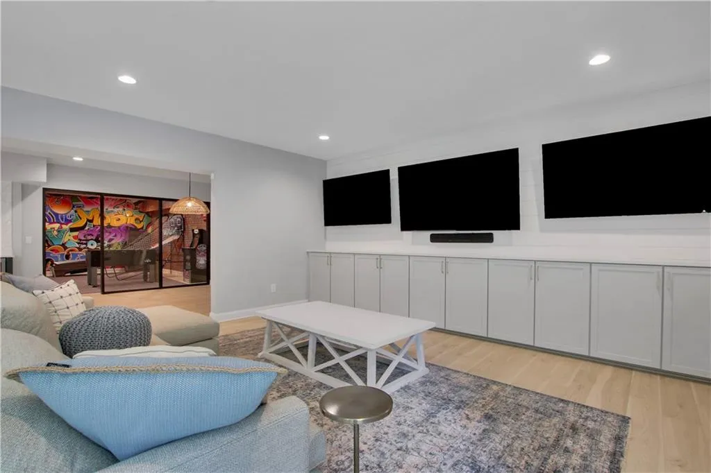 Basement Living room featuring light wood finished floors and recessed lighting
