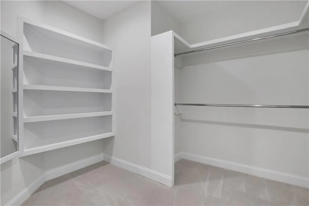 Primary closet features two walk in closets