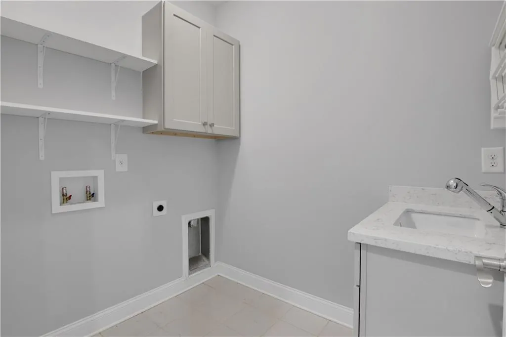 Laundry area upstairs featuring cabinet space, electric dryer hookup, and hookup for a washing machine and utility sink