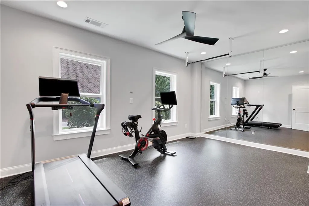 Workout area with ceiling fan and recessed lighting in basement. Can be a bedroom as well!