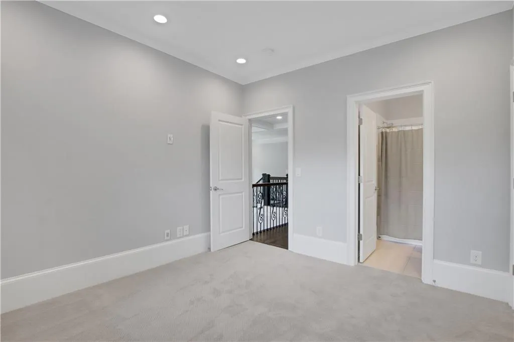 Upstairs bedroom with new carpet floors, recessed lighting, and ornamental molding