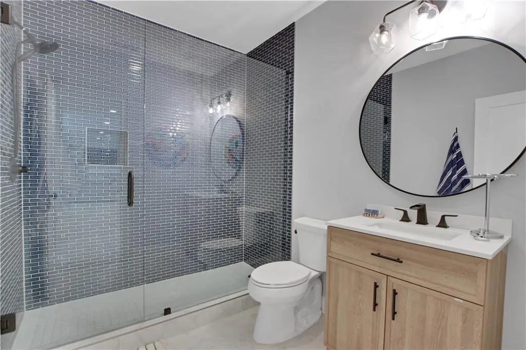Basement Bathroom with vanity and a shower stall