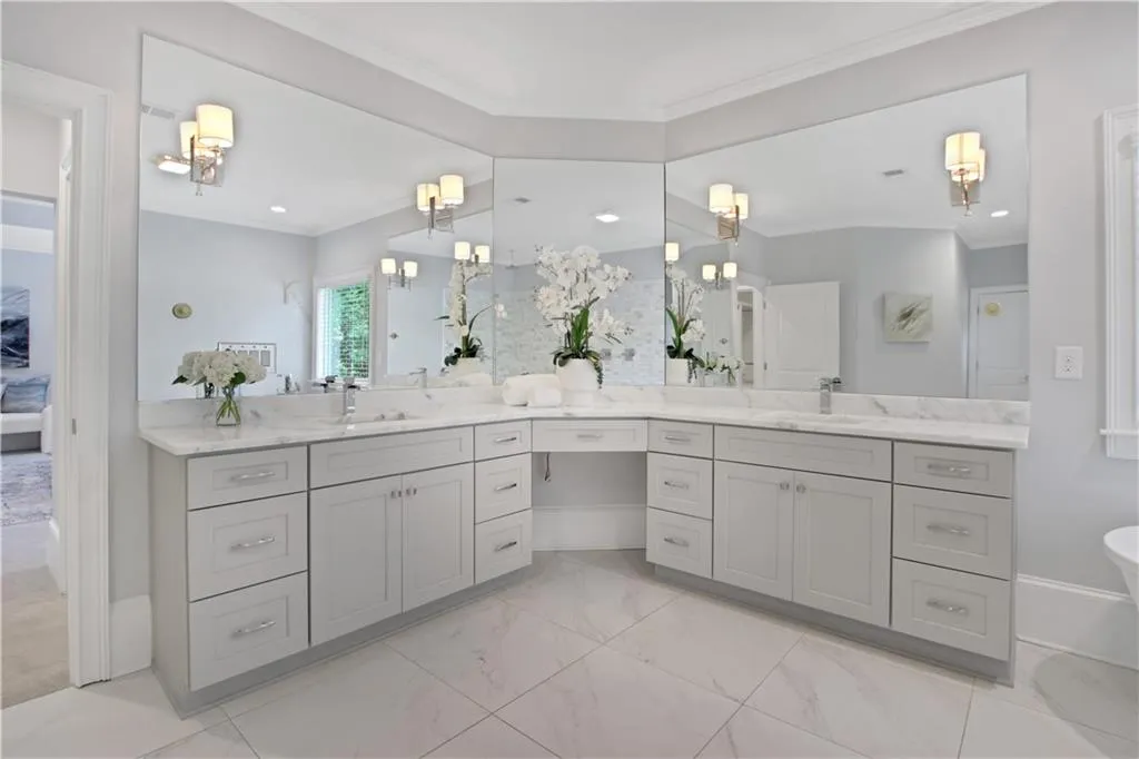 Bathroom with ornamental molding, vanity, marble finish floors, a chandelier, and connected bathroom