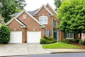 Brick exterior featuring a two-car garage