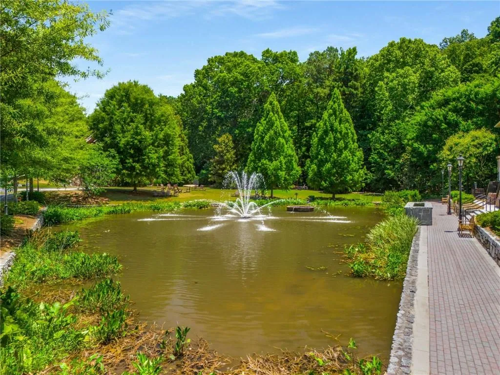 A view of the waterfall that sits between the upper and lower pools. Lots of pool decking, both covered and uncovered to sit and enjoy this space. The trees on the right border to a national forest that will never be touched.