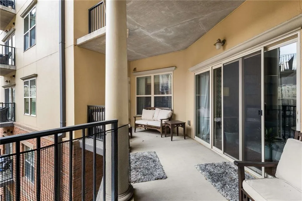 This covered balcony is an extension of your living space. Plenty of room for a table + chairs and a chaise lounger.