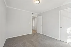 Unfurnished bedroom featuring carpet floors and baseboards