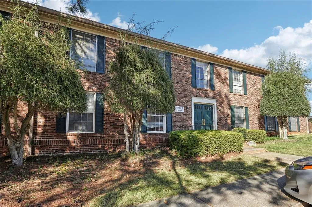 Colonial-style house featuring brick siding