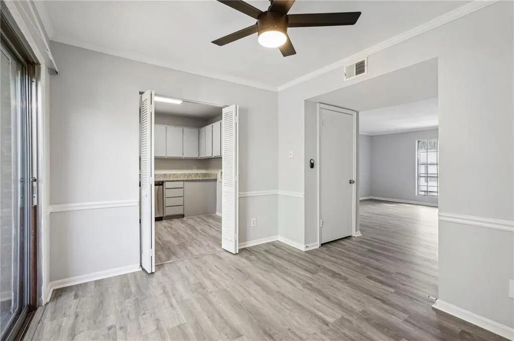 Unfurnished bedroom featuring ornamental molding, light wood-style flooring, and ceiling fan