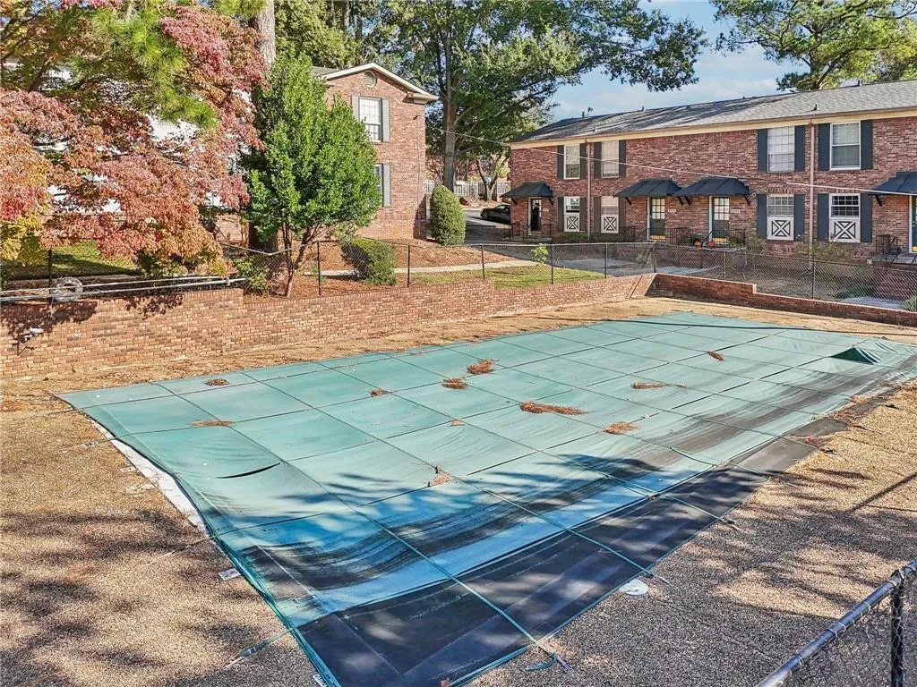 View of swimming pool featuring a covered pool