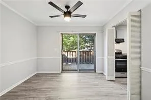 Spare room featuring ceiling fan, wood finished floors, and baseboards