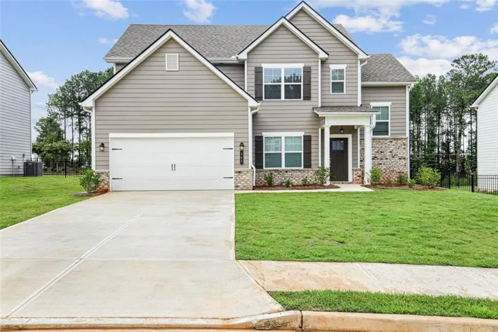 Craftsman inspired home with a front yard and central AC unit