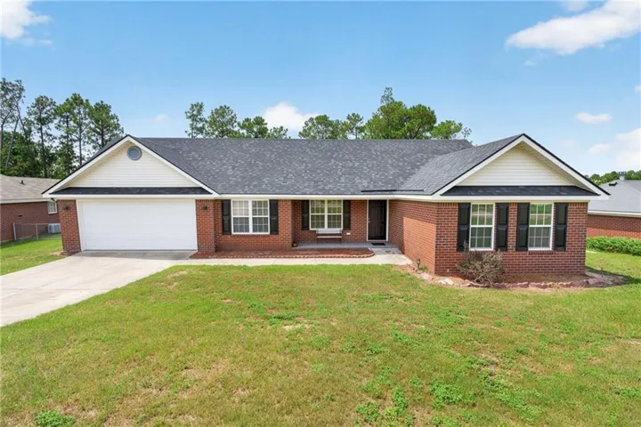 Brick exterior with white siding accents and a dark shingle roof