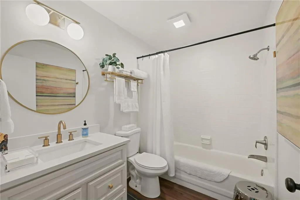 Secondary bathroom with single vanity offering storage options
