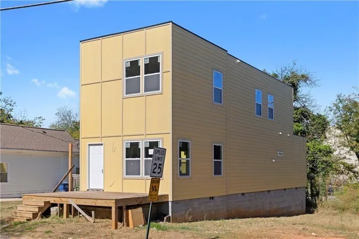 Contemporary two-story residence featuring light yellow siding