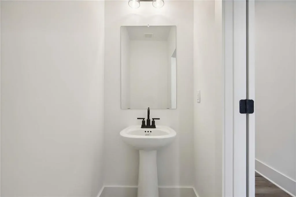 Powder room.  Photo example only of finished townhome.