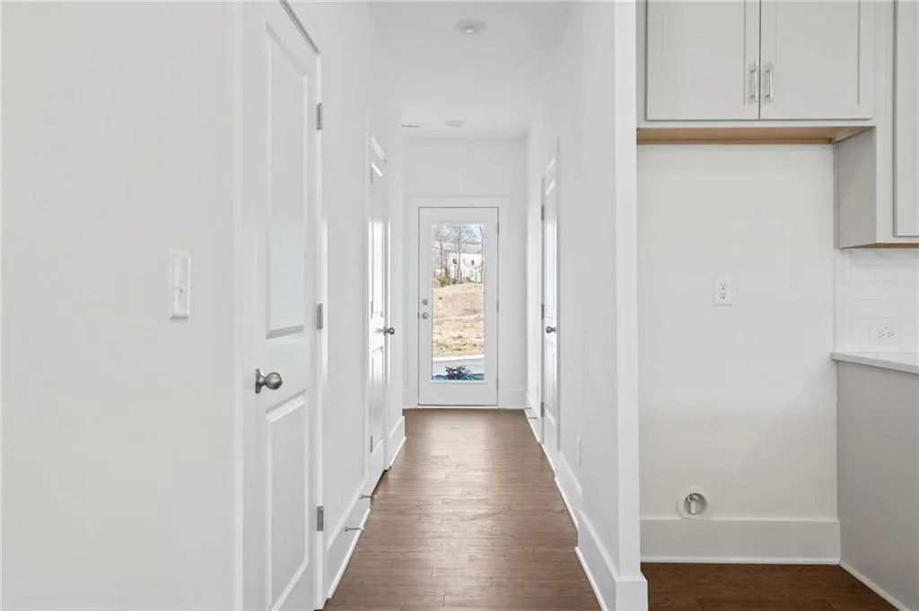 Back hallway leads to powder room & rear patio. Photo example only of finished townhome.