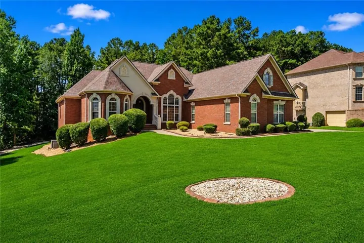 Brick exterior with gabled roof lines and arch-top windows