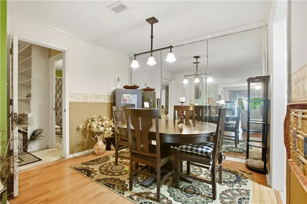 Dining room with light wood-style floors and crown molding