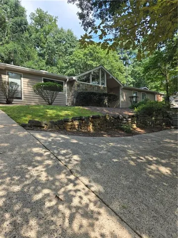 Siding exterior with stone facade accents and a vaulted entry