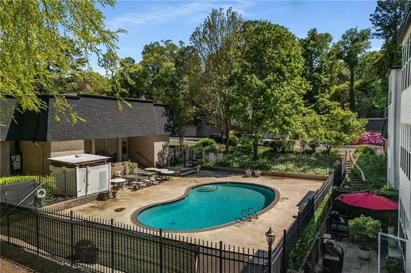 Pool with a patio area and fence Pool with a patio area and fence