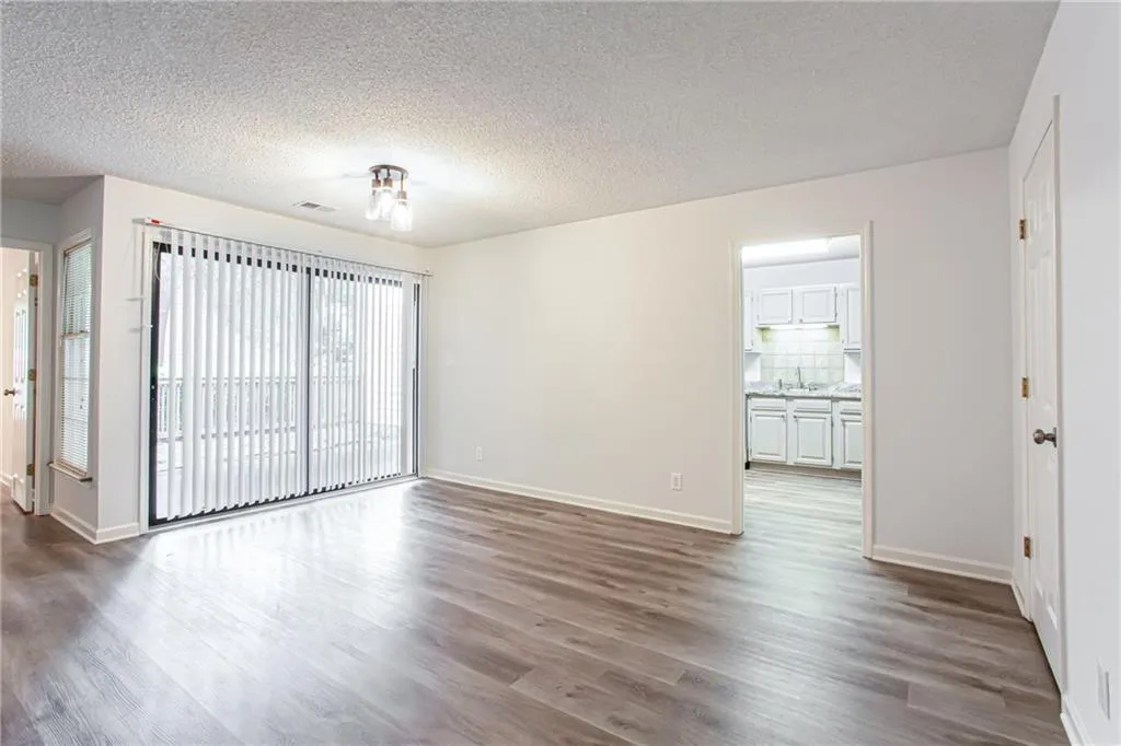 Unfurnished room with dark wood-style floors and a textured ceiling