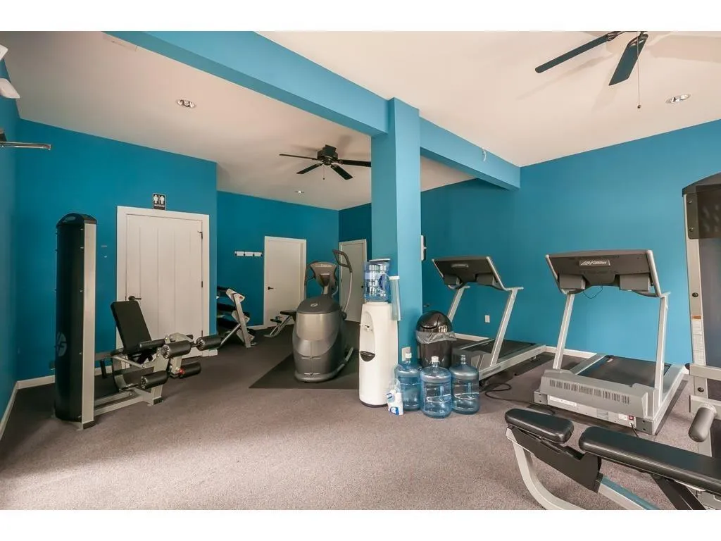Exercise room with a ceiling fan