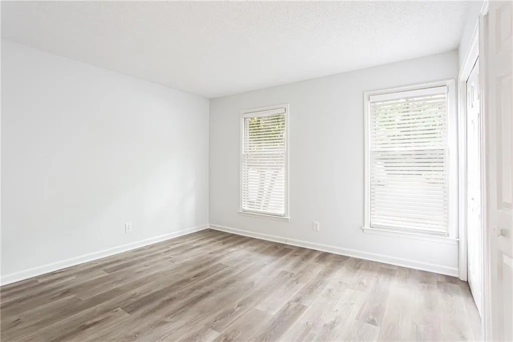 Unfurnished room featuring light wood finished floors and a textured ceiling