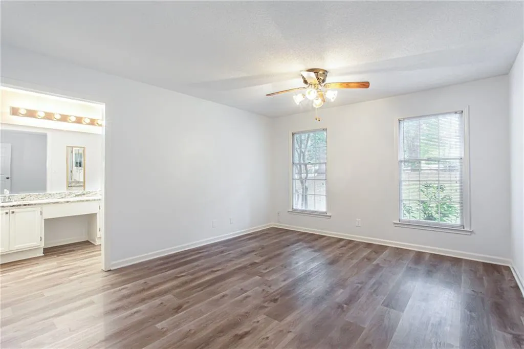 Unfurnished bedroom featuring light wood-style floors, a ceiling fan, and a textured ceiling