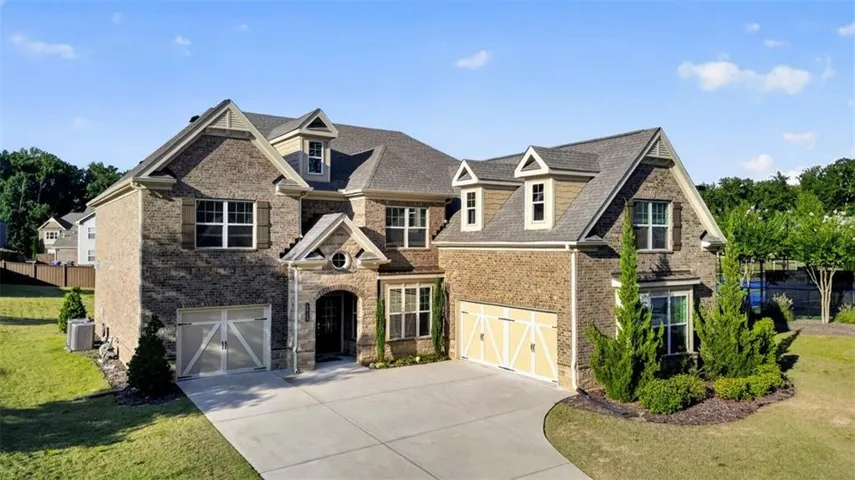 Stone and brick facade with multiple gables and dormer windows