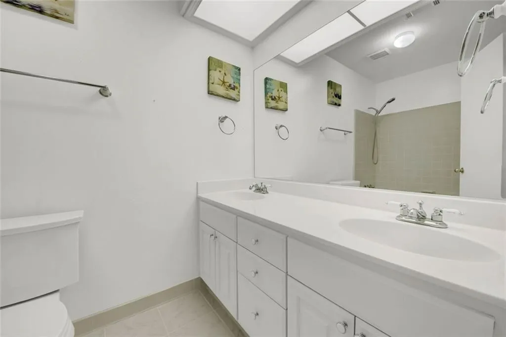 Hall Bathroom with Double Vanity, tile flooring