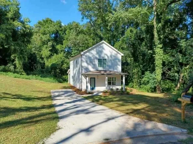 White siding exterior with a covered porch
