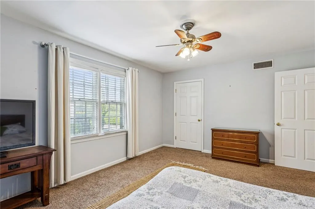Bedroom with carpet and a ceiling fan