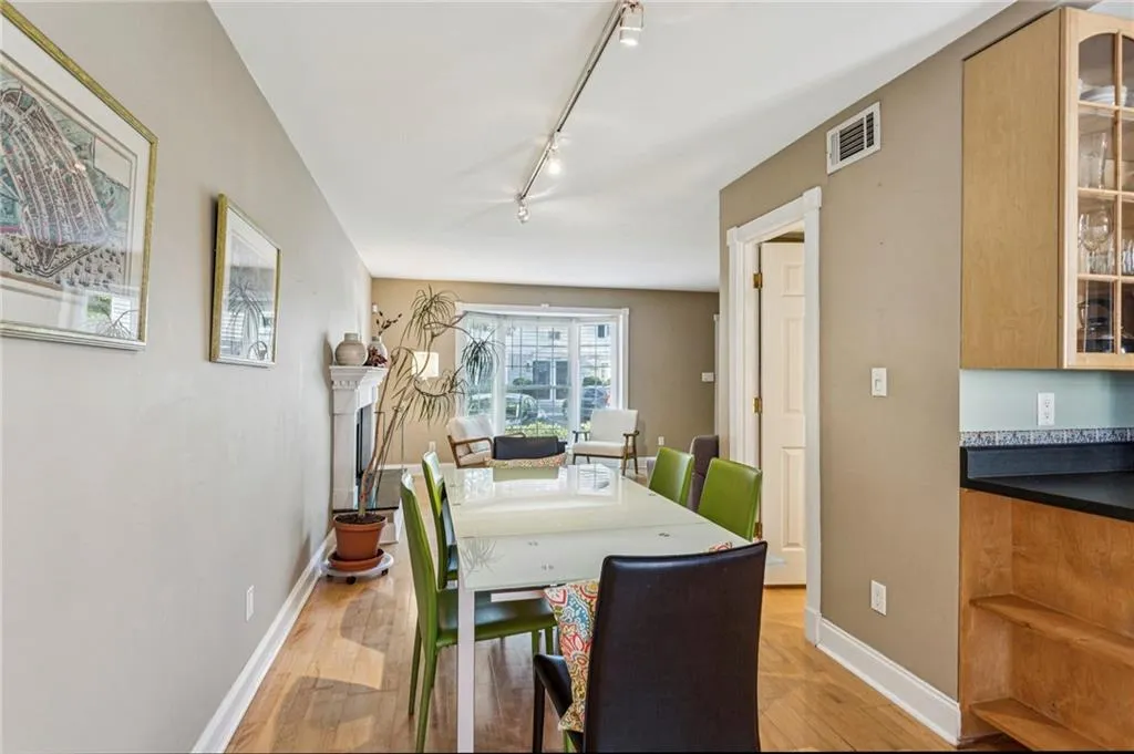 Dining room with rail lighting and light wood-type flooring