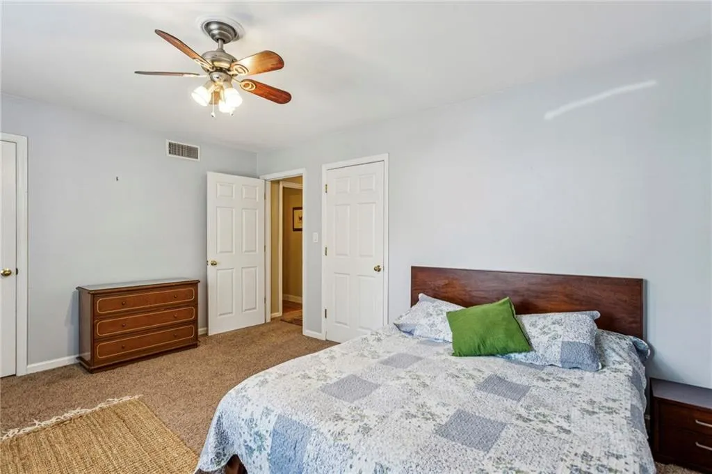 Bedroom with carpet and ceiling fan