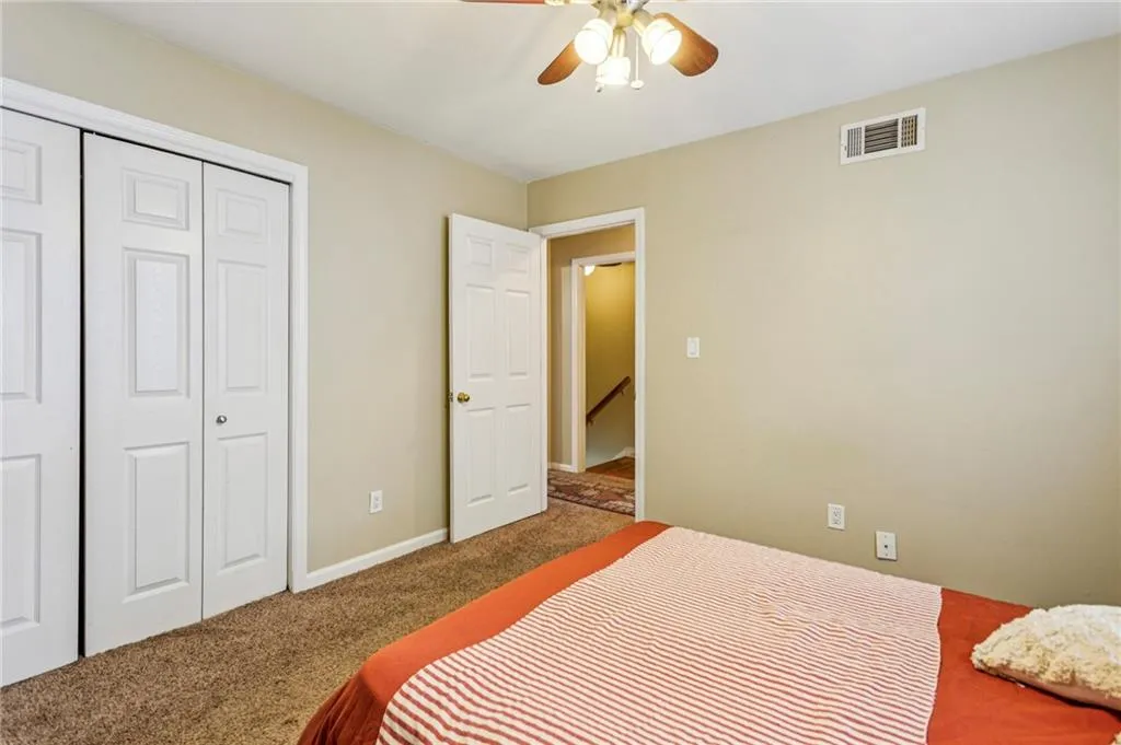 Bedroom with carpet, a closet, and ceiling fan Bedroom with carpet, a closet, and ceiling fan