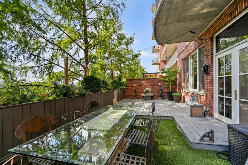 Private outdoor space with a deck, lighting, irrigation, outdoor dining and grill area