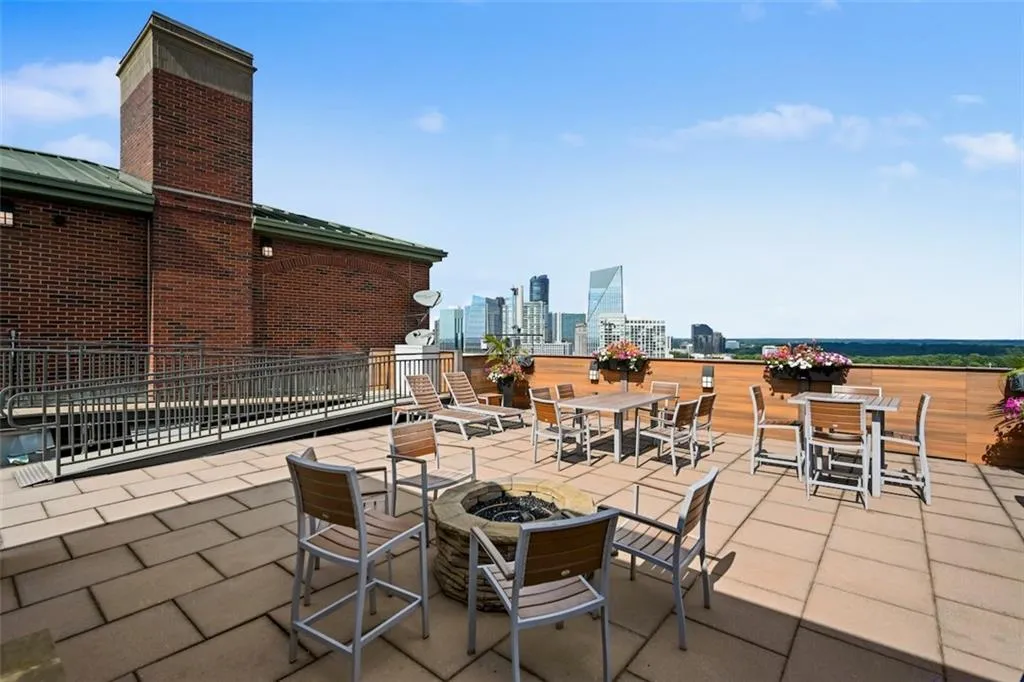 View of patio featuring a view of skyline, an outdoor fire pit, and outdoor dining space