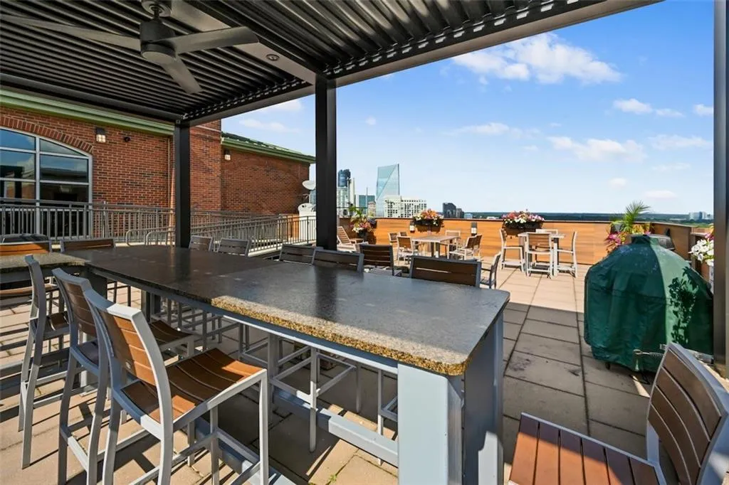 Roof top pergola, ceiling fan, outdoor dining area, a city view, and a patio